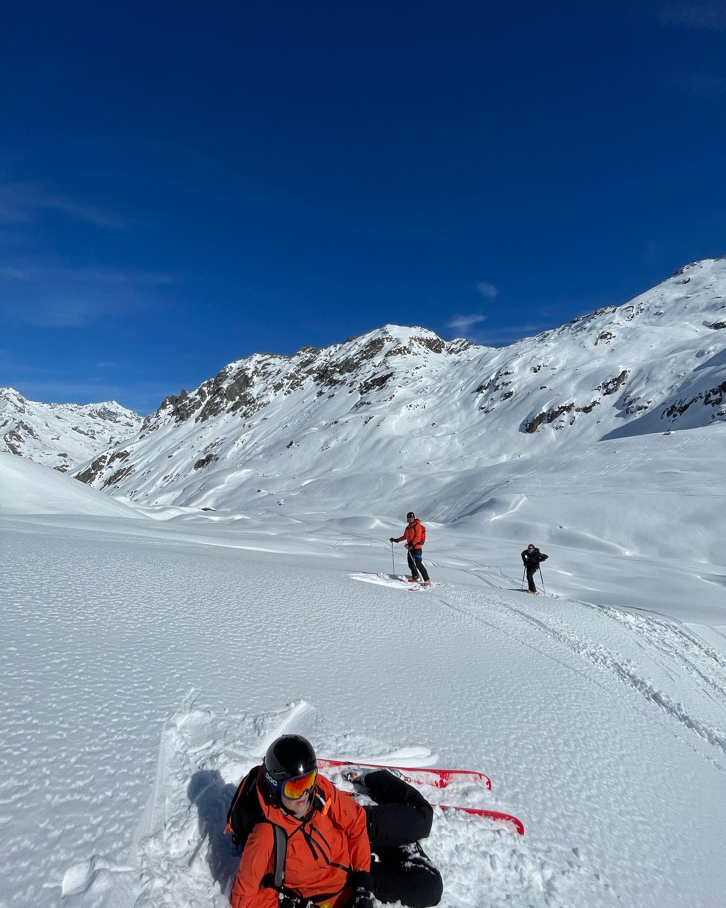 Skiers in a snowy mountain landscape